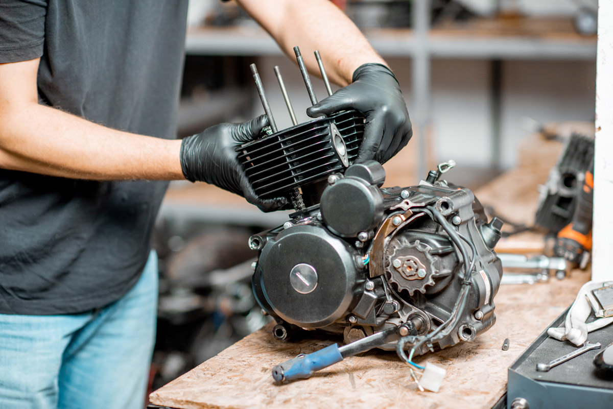 Technician rebuilding a motorcycle engine