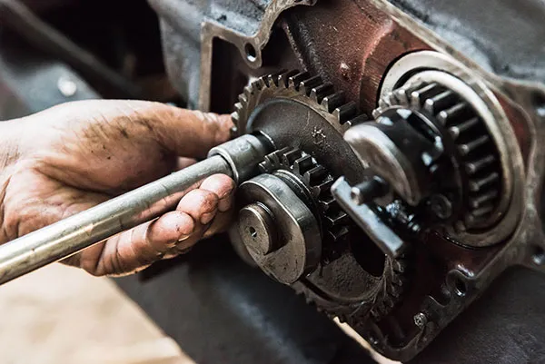 Mechanic repairing an engine gearbox